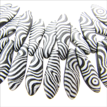 Load image into Gallery viewer, Czech Daggers 5X16mm Black &amp; White Lasered Contours Qty:25 Strung
